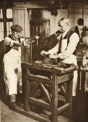 Two elderly locksmiths cutting key barrels, from Wonderful London, published 1926-27